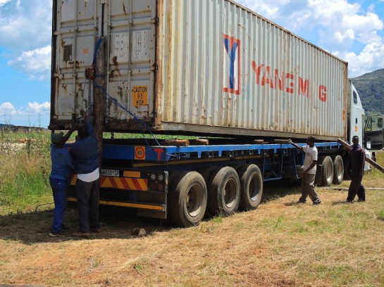 slipping poles under the shipping container