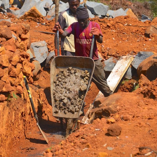 Garikai tips the first barrow load of concrete
