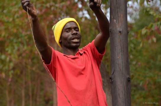 George holding barbed wire strainer