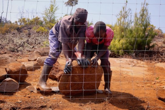 and moving stones to hold the bottom down securely