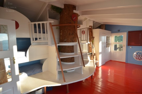 Inside the tree house showing our sweeping staircase up to the bunks