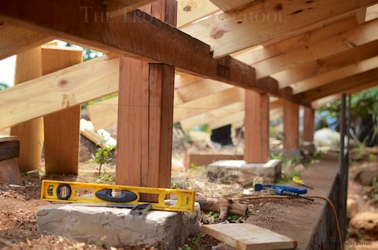 Pillars supporting the external overhang forming a sheltered walkway